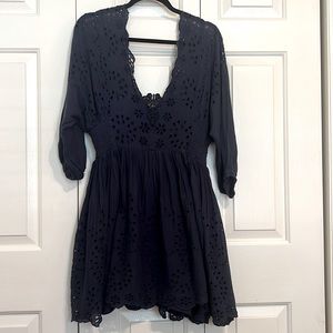 Navy blue eyelet fabric dress, lined skirt with cinching tied bodice.